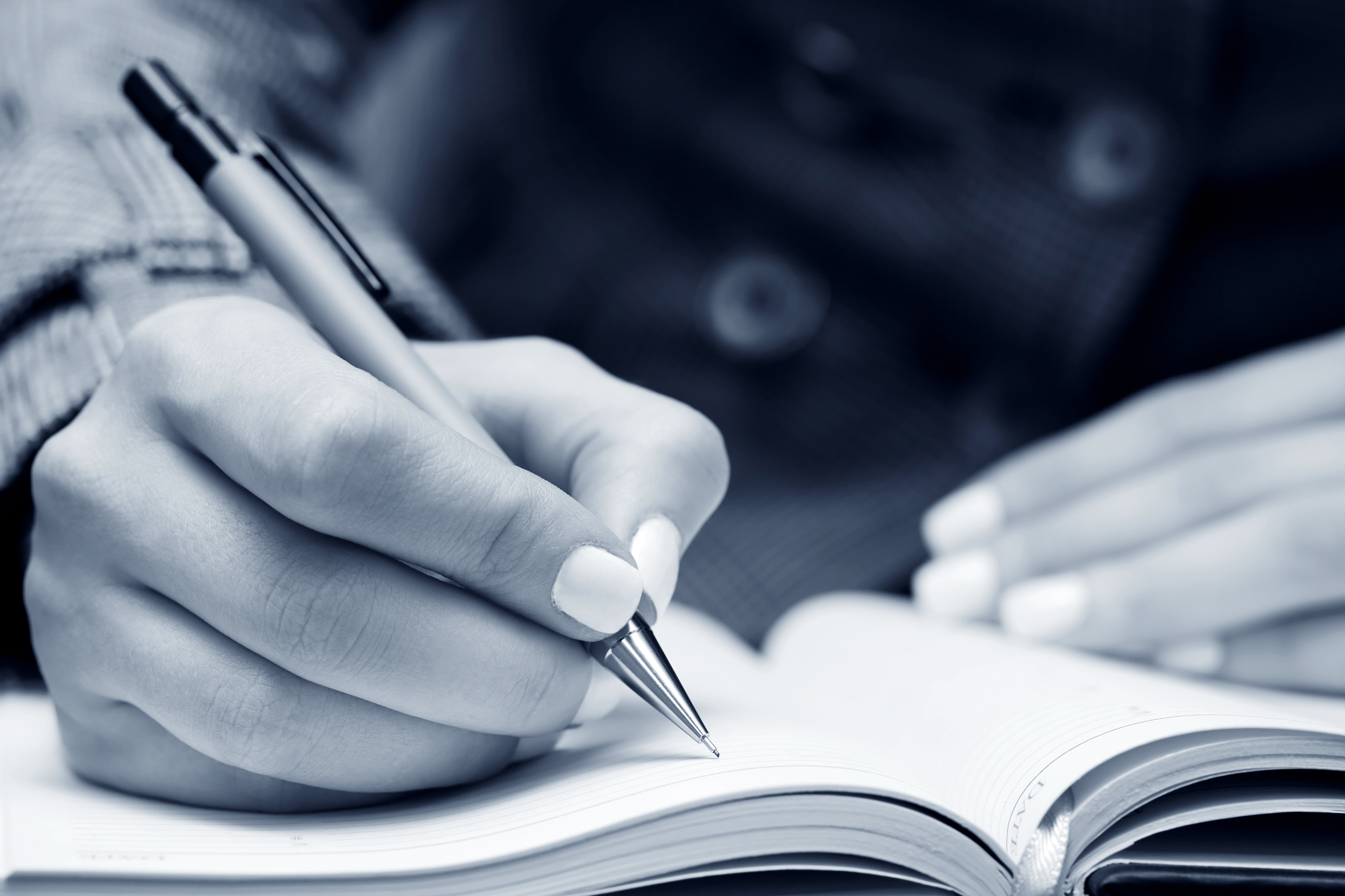 bigstock-business-woman-writing-in-note-73423432