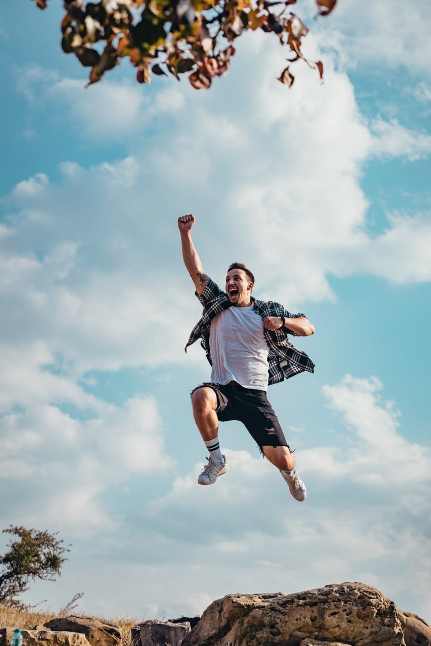 man jumping from a rock