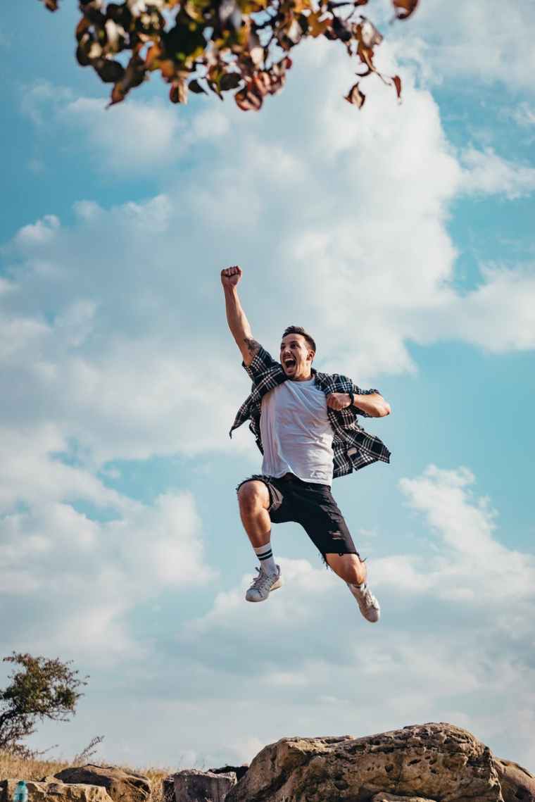 man jumping from a rock